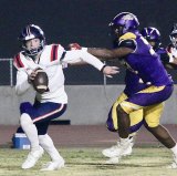 Lemoore's Dorian Davis puts pressure on Justin Garza quarterback Caleb Mathews in the first half of Friday's game  won by Lemoore.